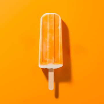 Orange creamsicle ice cream isolated on ORANGE background, generative AI