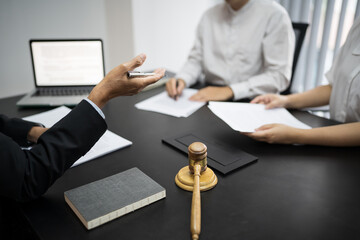 Lawyer Legal counsel presents to the client a signed contract with gavel and legal law. justice and lawyer Business partnership meeting concept.