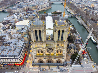 Aerial drone view of Notre-Dame Cathedral during reparation works in Paris, France. The Restoration of the cathedral Notre Dame in Paris is due to the fact that a massive fire ravaged its wooden roof - obrazy, fototapety, plakaty