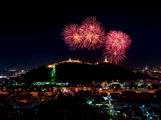 The most famous firework Pra Nakorn Kiri festival in Petchaburi Thailand. Fireworks display over three pagodas on Khao Wang hill at night. 