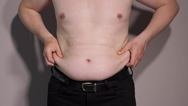 male naked torso with a thick belly. wrinkles on the male abdomen