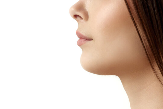 Close-up cropped profile image of female face part, chin, lips and nose over white studio background. Double chin surgery. Concept of natural female beauty, body and skincare, cosmetology, health, ad
