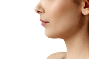 Close-up cropped profile image of female face part, chin, lips and nose over white studio background. Double chin surgery. Concept of natural female beauty, body and skincare, cosmetology, health, ad