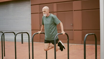 80 years old man making sport and different activities outdoor. Senior man training in the city. Concept about healthy lifestyle and seniority