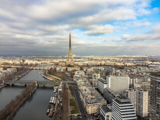 Fototapeta premium Aerial drone view of the Eiffel Tower. Wrought-iron lattice tower on the Champ de Mars and the Seine river in Paris, France.