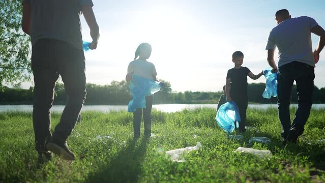 group of volunteers clean up the trash. environmental protection ecology cleaning from garbage plastic concept. group people volunteers world collects plastic bottles garbage in bags silhouette