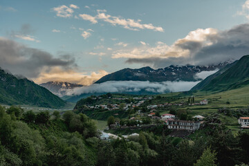Sioni ancient stone watch tower, overlooking Terek River Valley, on background of Caucasus Mountains