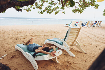 Fototapeta na wymiar woman holiday sand ocean resort lifestyle smiling lying sea beach sunbed