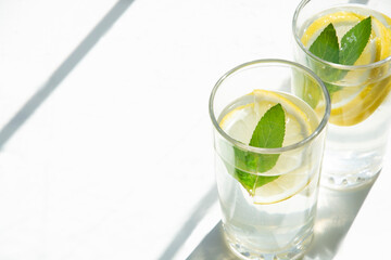 Lemon water with ice and mint in glass