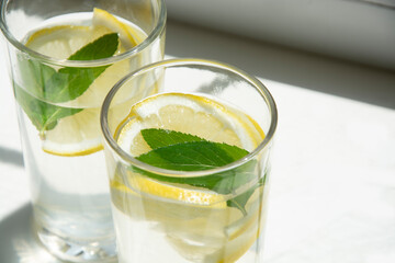 Lemon water with ice and mint in glass