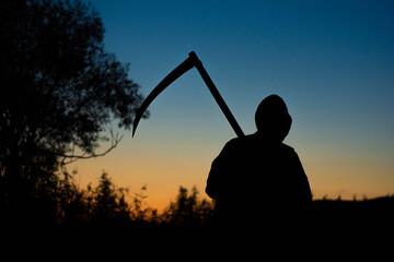 grim reaper  the death itself  scary horror shot of Grim Reaper holding scythe