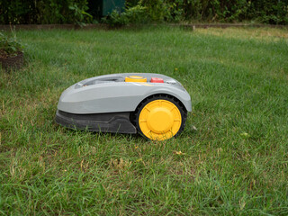 Robot lawnmower mows the lawn. Robot lawn mower close-up.