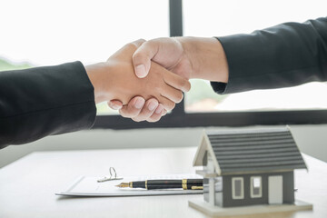 handshake after signing a business contract by Real estate agents and buyers, renting, buying, mortgage, loan or home insurance