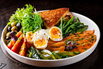 salmon, green bean, olive, salad and soft boiled egg