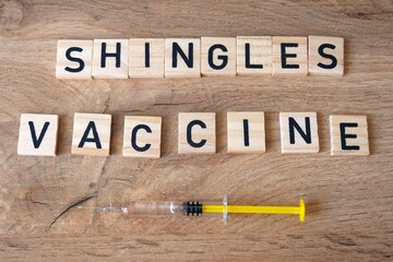 Shingles vaccine concept. Syringe on the table.
