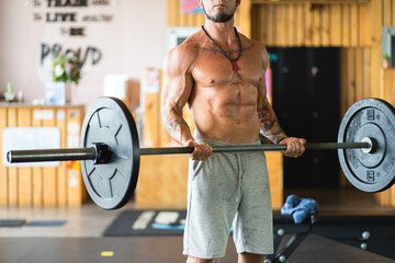 Fit man doing weights with a bar