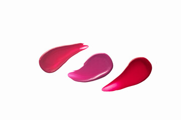 Swatches of red and pink lipstick on a white background