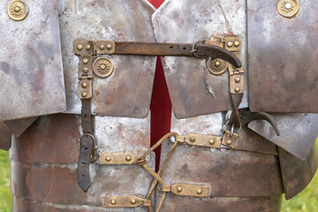 foreground detail photography of armor af a soldier froma ancient roman empire, lorica segmentata