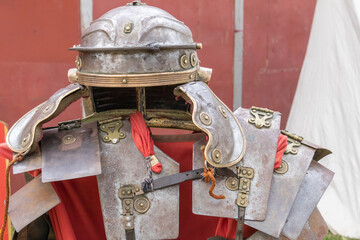 foreground of helmet and armor of an ancient roman empire soldier, lorica segmentata and imperial helmet or galea