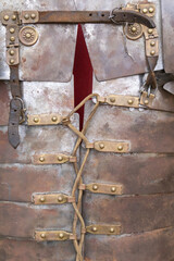 foreground detail photography of armor af a soldier froma ancient roman empire, lorica segmentata