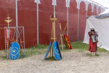 outdoor scene with shields and clothing of legionary soldier of the ancient roman empire