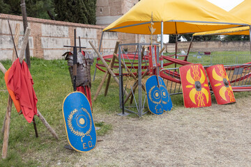 outdoor scene with shields and clothing of legionary soldier of the ancient roman empire