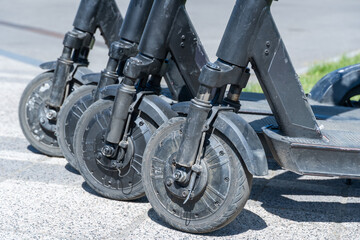 Obraz premium Details mechanism of used electric scooter close up. Wheel, shock absorber public mobile transport. Equipment technology economical vehicle in contemporary urban. Device ecological dockless transport.