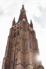 A low angle photo of the Brugge cathedral tower