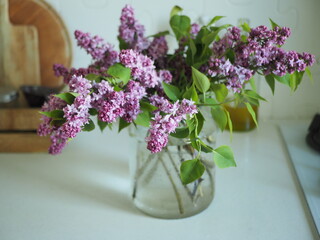 a bouquet of lilacs and a vase