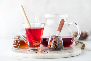 Hibiscus tea with honey against a light back ground.