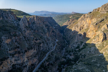 Aerial summer sunny view of serpentine mountain road near Topolia Gorge, Crete, Greece