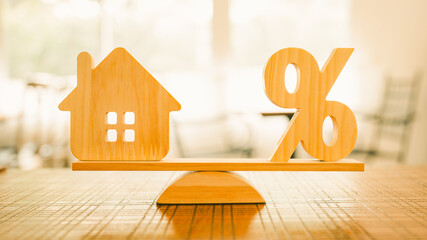 Wooden house model, Percentage symbol on wooden balance with sunlight, Concepts of interest, a...