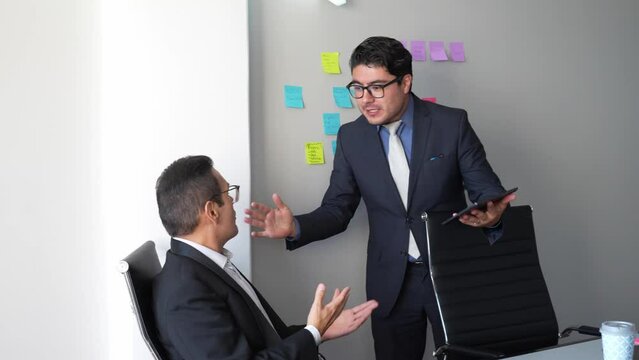 Angry boss arguing with employee, frustrated businessman scolding a worker having an argument, crisis, conflict and discussion in a meeting room office, stress at work environment CEO firing a clerk