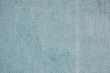 The cement wall painted turquoise. Background, texture.