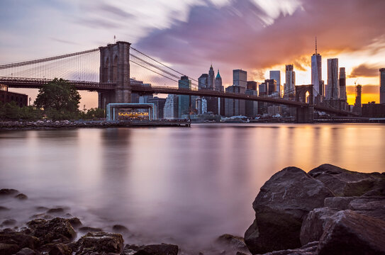 Manhattan Skyline with Brooklyn Bridge in front at dusk, New York City, long term exposure