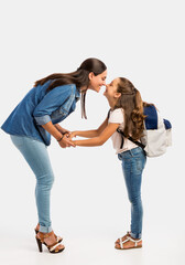 Fototapeta premium Mother saying goodbye to her daughter on first day of school