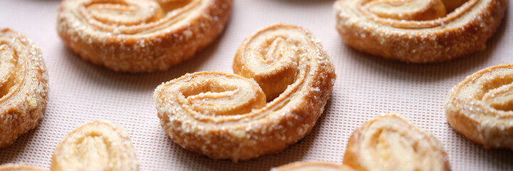 Tasty sweet pastry cookies with sugar sprinkle on pink backdrop