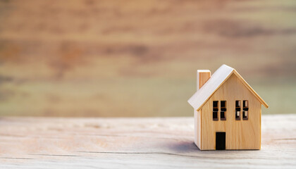 Obraz na płótnie Canvas wood house model for real estate property buy sale concept loan