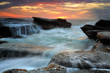 Waves wash through one of the rock channels at Culburra