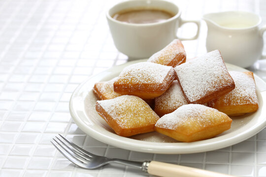 homemade new orleans beignet donuts and a cup of coffee