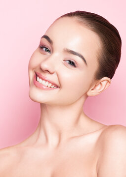 Beauty fashion model girl natural makeup with cute smile on pink background