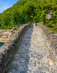 Fototapeta na wymiar Roman bridge (Ponte dei Salti) crossing the Verzasca River at Lavertezzo in the Verzasca Valley, Canton of Ticino, Switzerland, Europe
