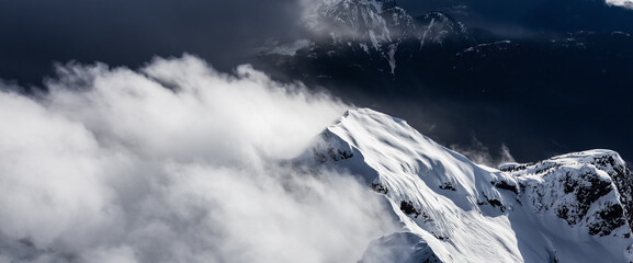 Canadian Coastal Mountain Landscape covered in Clouds. Aerial Panorama