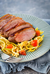 Roasted duck breast and zucchini noodles with tomatoes, healthy eating