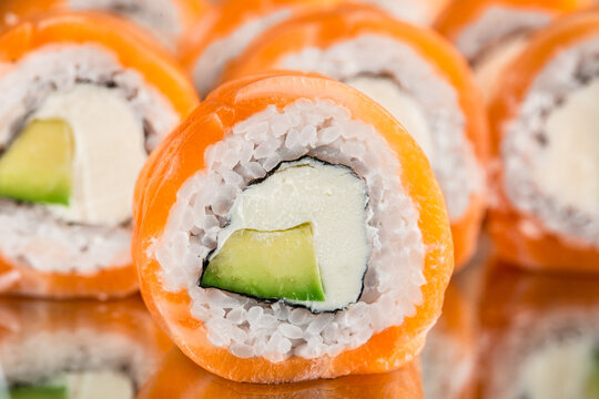 Philadelphia roll on mirror. Made of salmon, avocado, cheese and rice