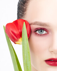 Clseup red lips with tulip flower. Sexy lipstick. Sensual mouth and Sensuality touch.