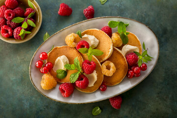 Homemade pancakes with fresh raspberries and mint, overhead shot. Pancakes for Breakfast.