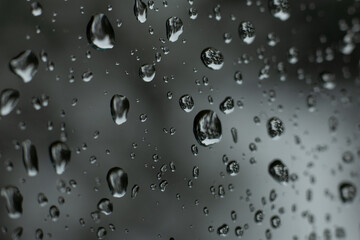 Water drops on glass. Raindrops on the car glass. Thunderstorm Climatic rain on window glass
