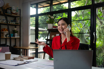 Businesswoman searching through laptop for online real estate on office desk