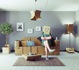 The room with card cardboard boxes instead of furniture and the man with box on the head. Media mixed concept